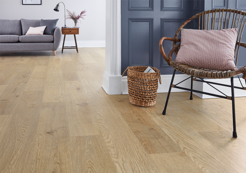 luxury vinyl plank flooring in living room with chair and decorative basket.